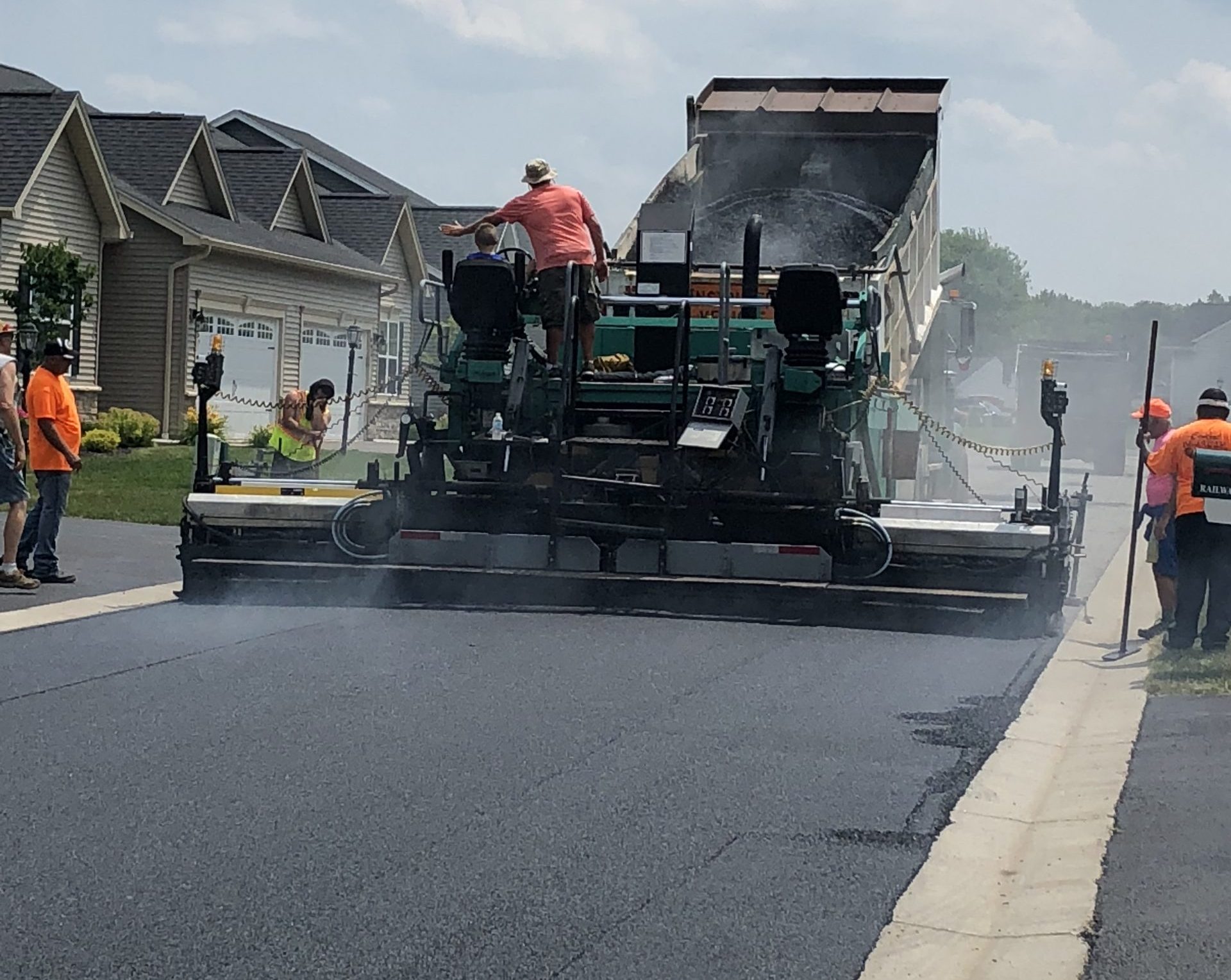 Central Roadways road paving with asphalt, machinery and dump truck.